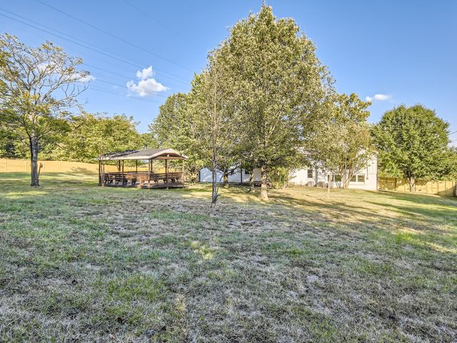 a view of outdoor space with garden and trees