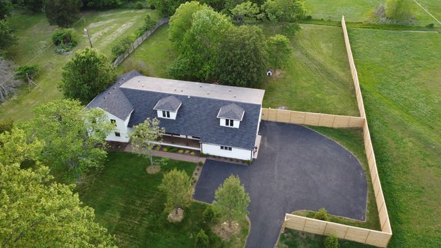 an aerial view of a house with a yard