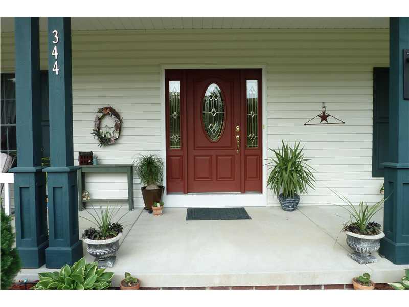 Exterior Front. Lovely entry ready for arrival of your guests! ADT security system installed by owners.