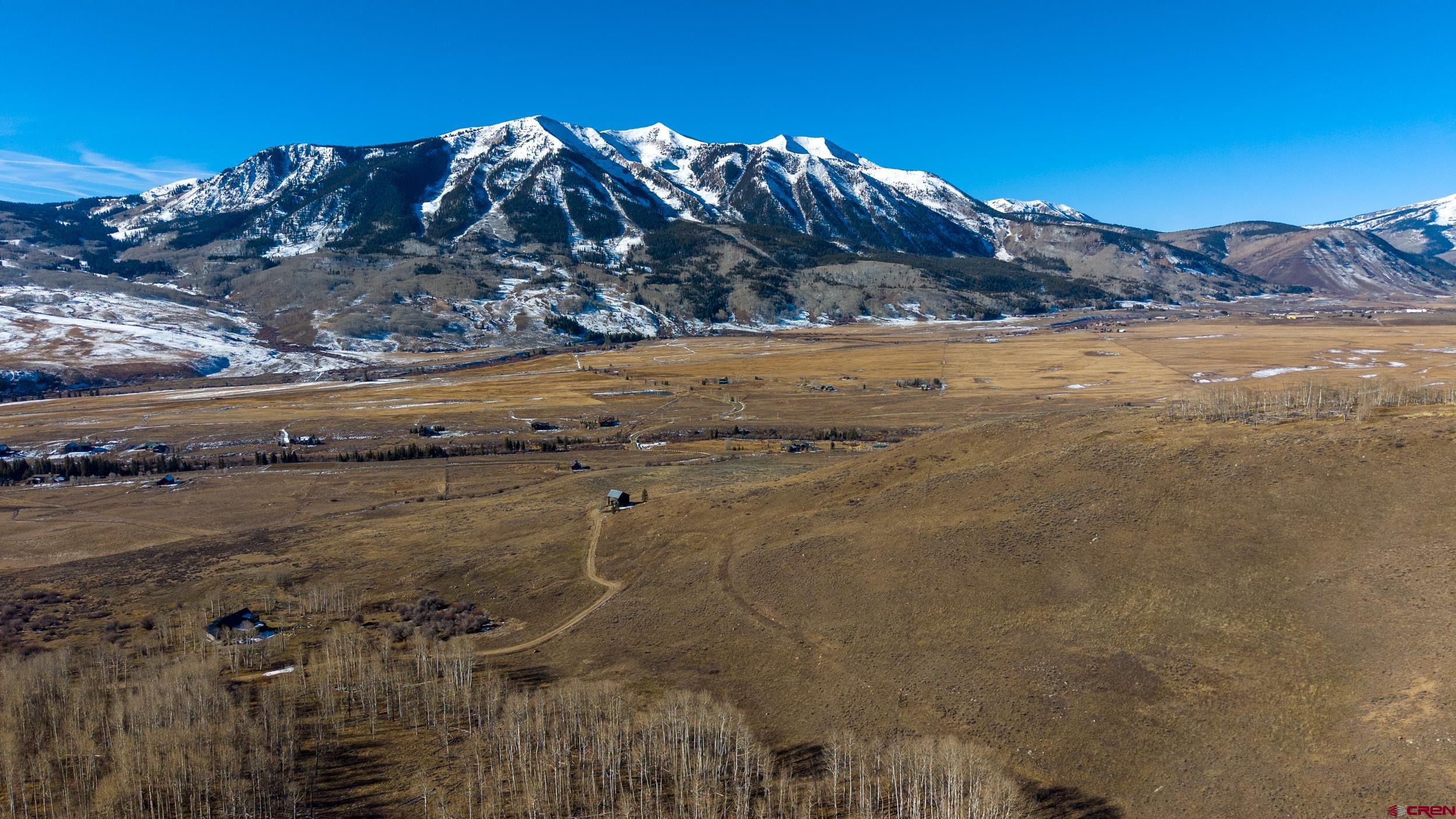 996 Lower Highlands Road Crested Butte, CO 81224 - Photo 4 of 20 a view of a lake with a mountain in the background