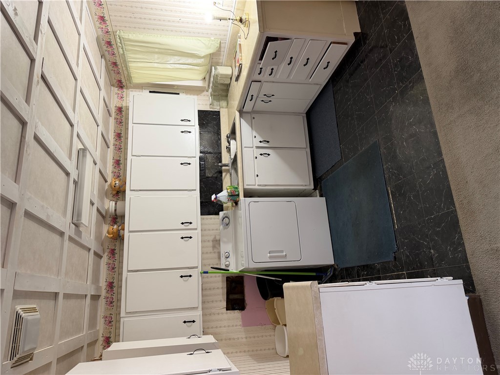 4867 Rittenhouse Drive Dayton, OH 45424 - Photo 7 of 17 This functional utility space provides efficient laundry facilities and ample storage.