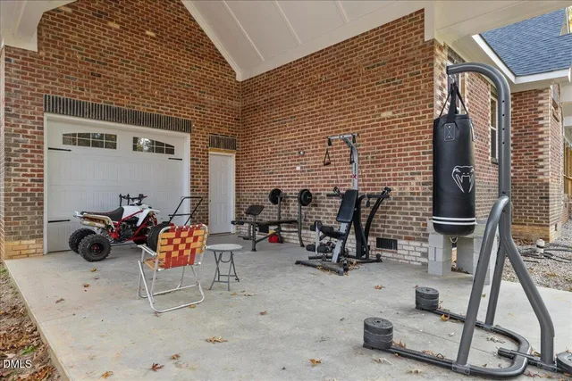a view of a patio with couple of chairs and potted plants
