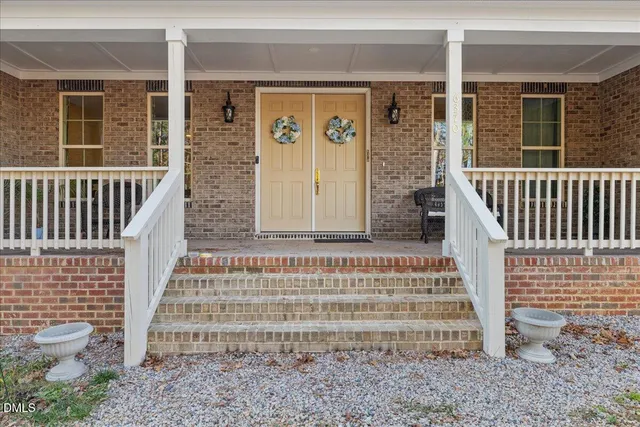 a view of front door of house with stairs