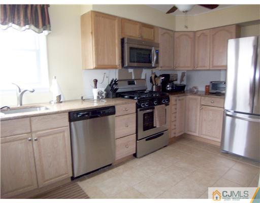 8 Farmingdale Road Fords, NJ 08863 - Photo 3 of 15 a kitchen with a sink stove and refrigerator