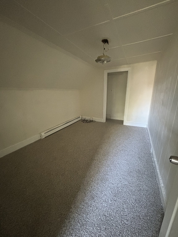 9 Pleasant Terrace Worcester, MA 01609 - Photo 21 of 27 an empty room with a ceiling fan and carpet