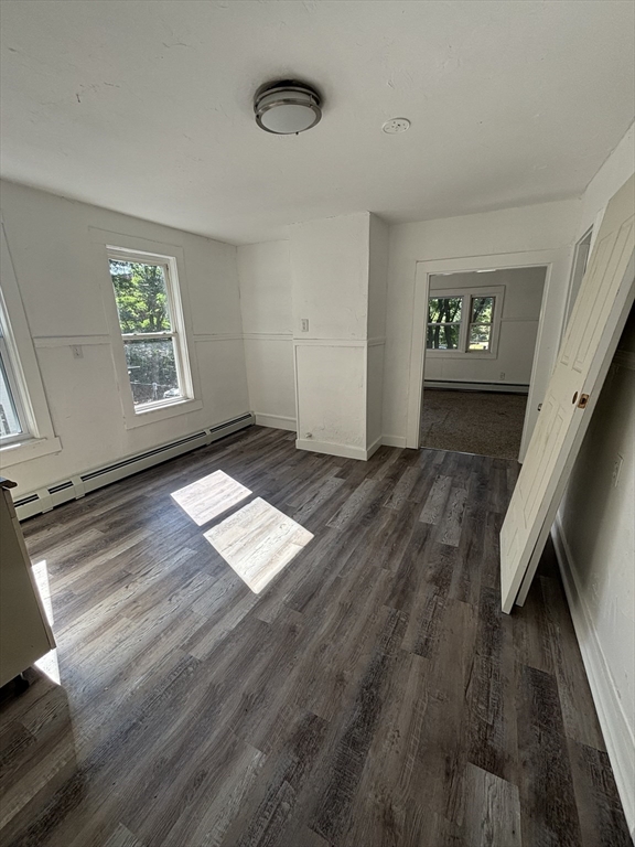 9 Pleasant Terrace Worcester, MA 01609 - Photo 23 of 27 an empty room with wooden floor and windows