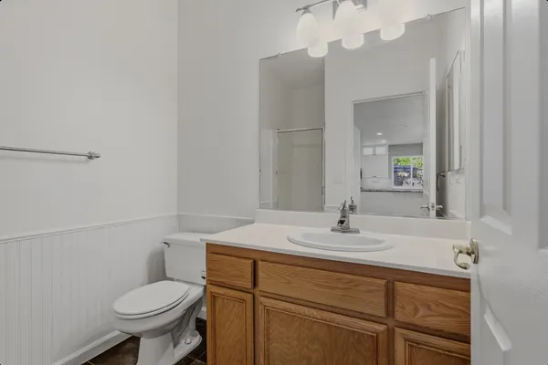 a bathroom with a sink toilet and a mirror
