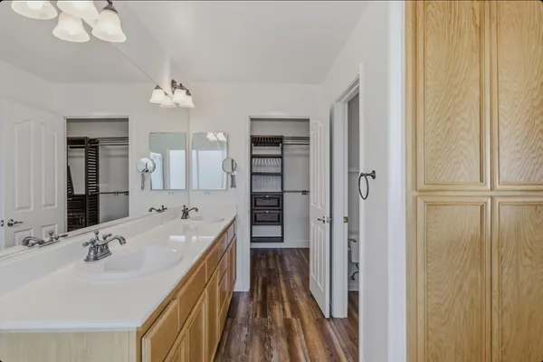 a en suite bathroom with a sink double vanity and a mirror
