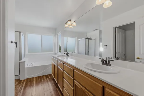 a bathroom with a sink a tub and a mirror