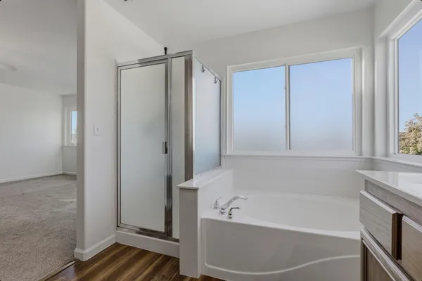 a bathroom with a bathtub and a shower