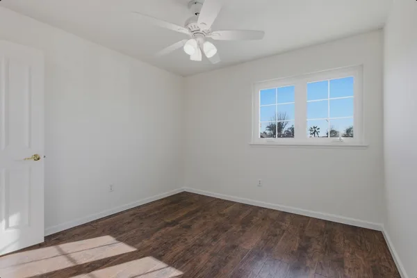 wooden floor in an empty room with a window