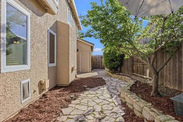 a pathway of a house with a yard