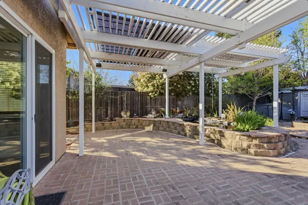 a view of a patio with table and chairs and potted plants