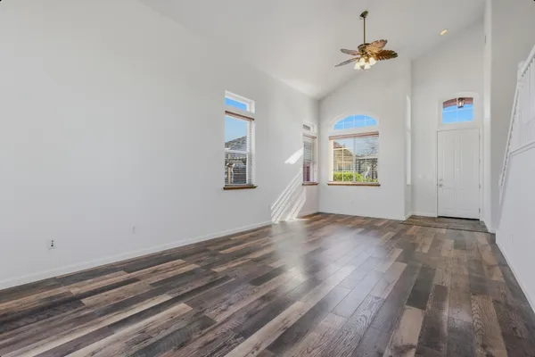 wooden floor in an empty room with a window