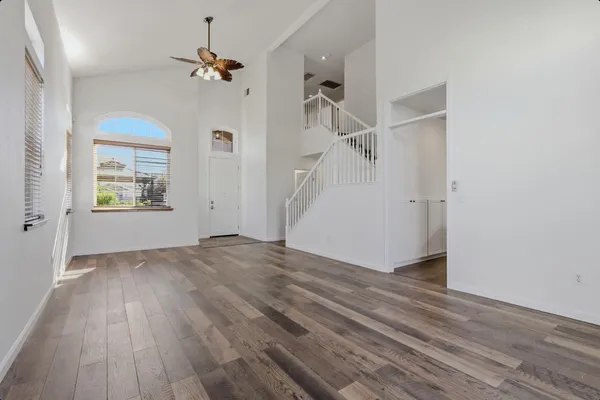 wooden floor in an empty room with a window