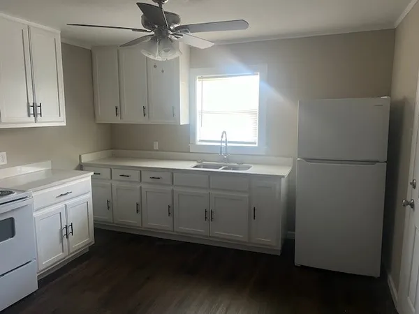 a kitchen with appliances cabinets and a sink