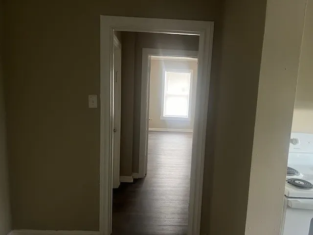 a view of hallway with wooden floor