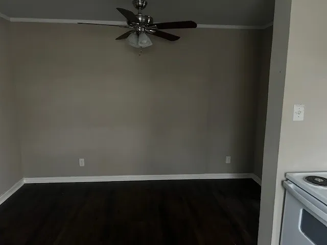 a view of a small space with wooden floor and a window