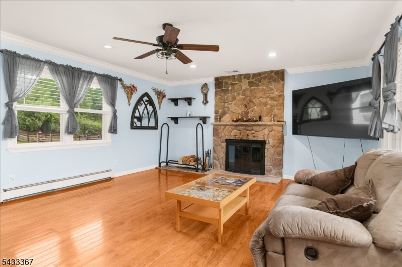 650 Woodglen Road Glen Gardner, NJ 08826 - Photo 4 of 28 a living room with furniture a flat screen tv and a fireplace