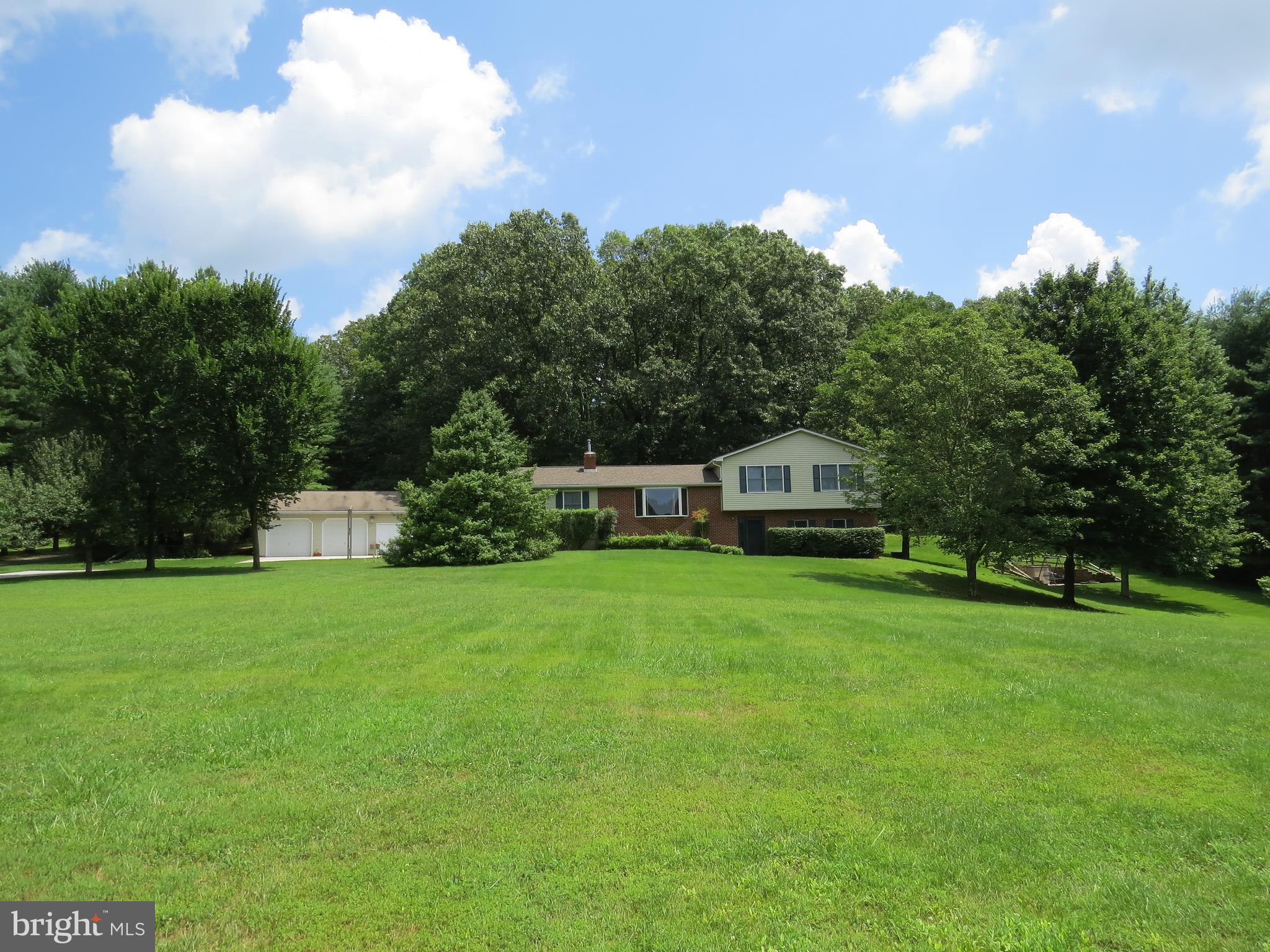 3165 Falls Road Hampstead, MD 21074 - Photo 1 of 30 a front view of a house with a garden