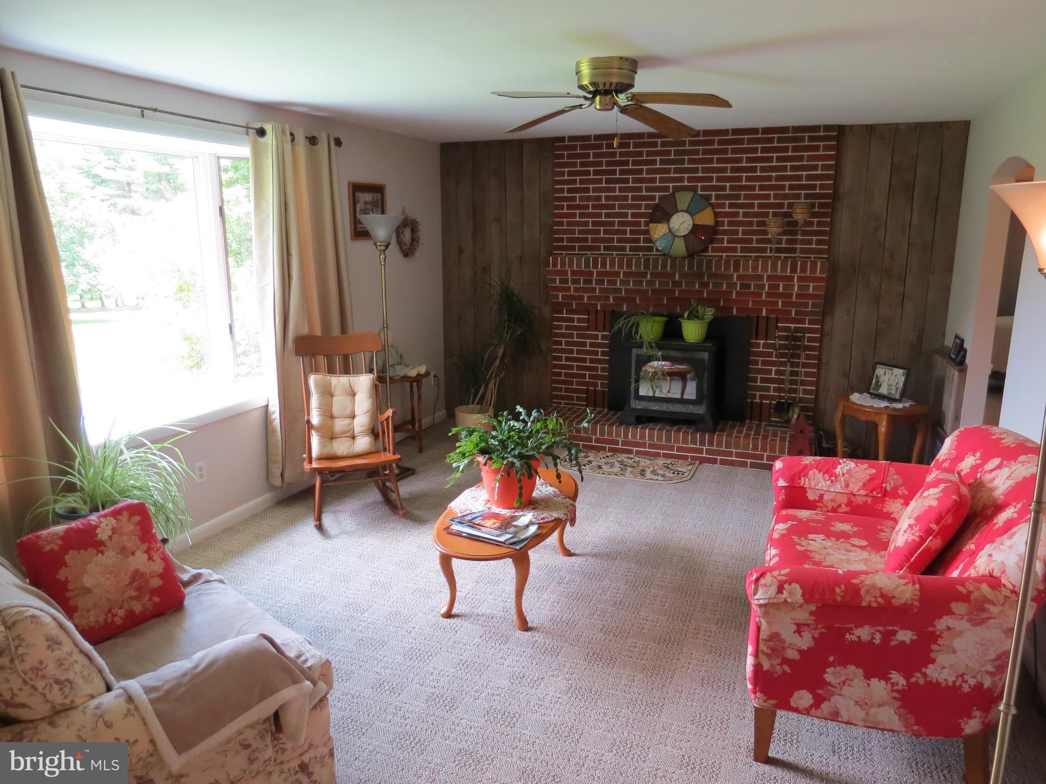 3165 Falls Road Hampstead, MD 21074 - Photo 3 of 30 a living room with furniture a fireplace and a window