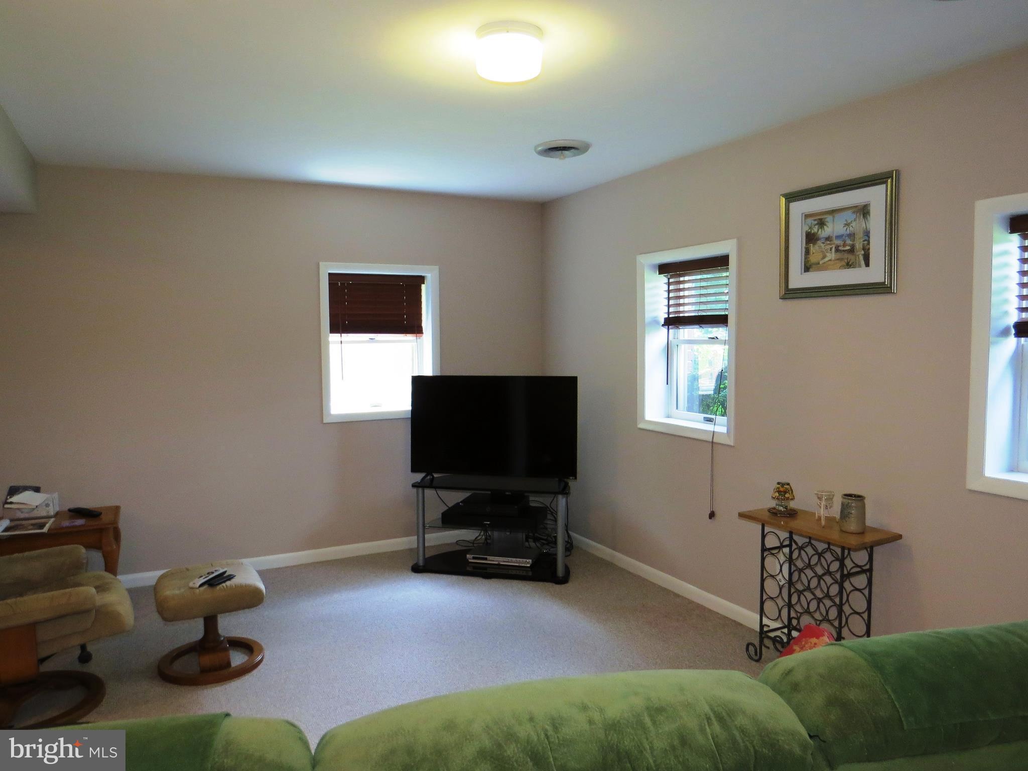 3165 Falls Road Hampstead, MD 21074 - Photo 22 of 30 a living room with furniture and a flat screen tv