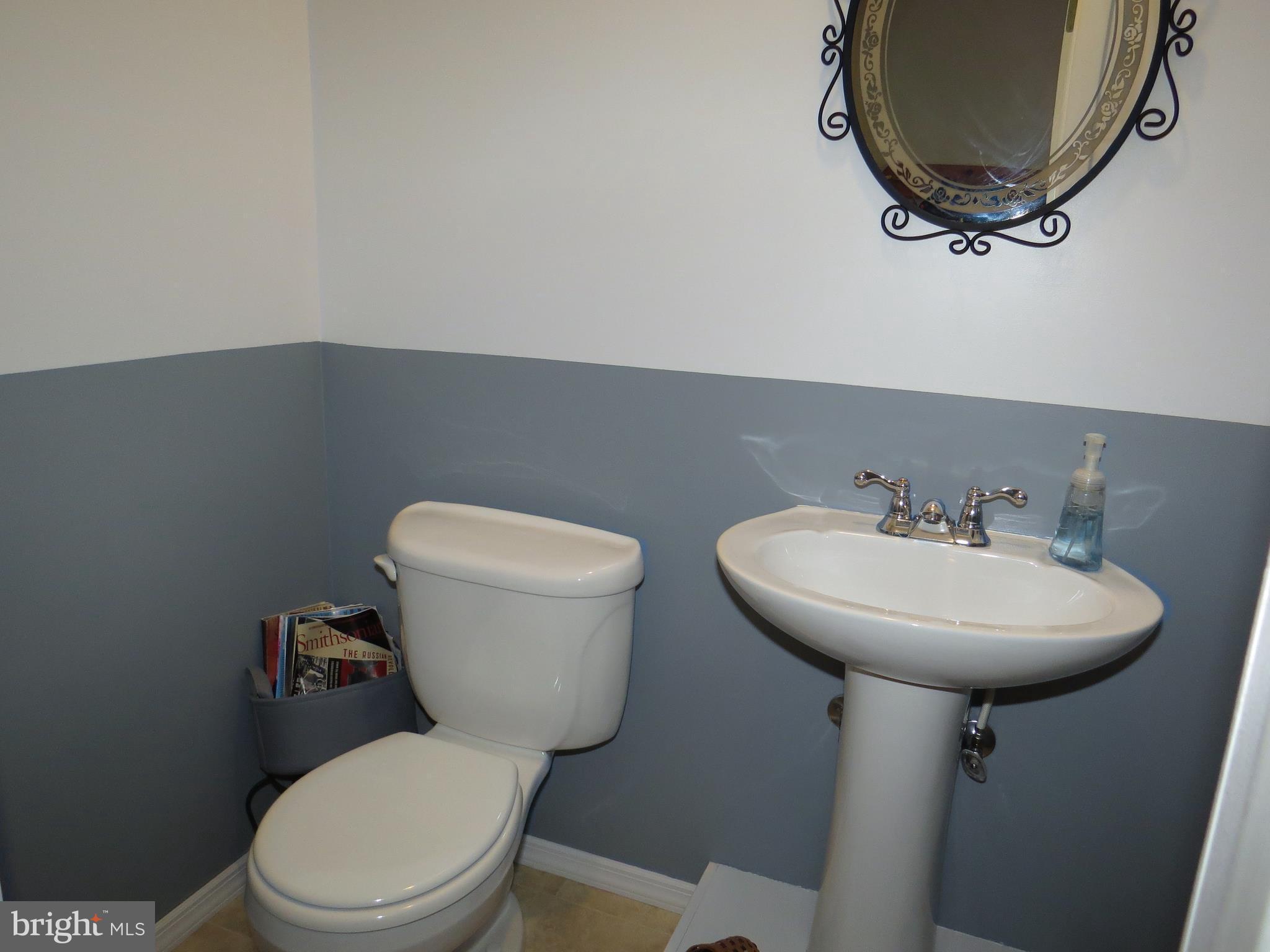 3165 Falls Road Hampstead, MD 21074 - Photo 23 of 30 a bathroom with a toilet a sink and a mirror