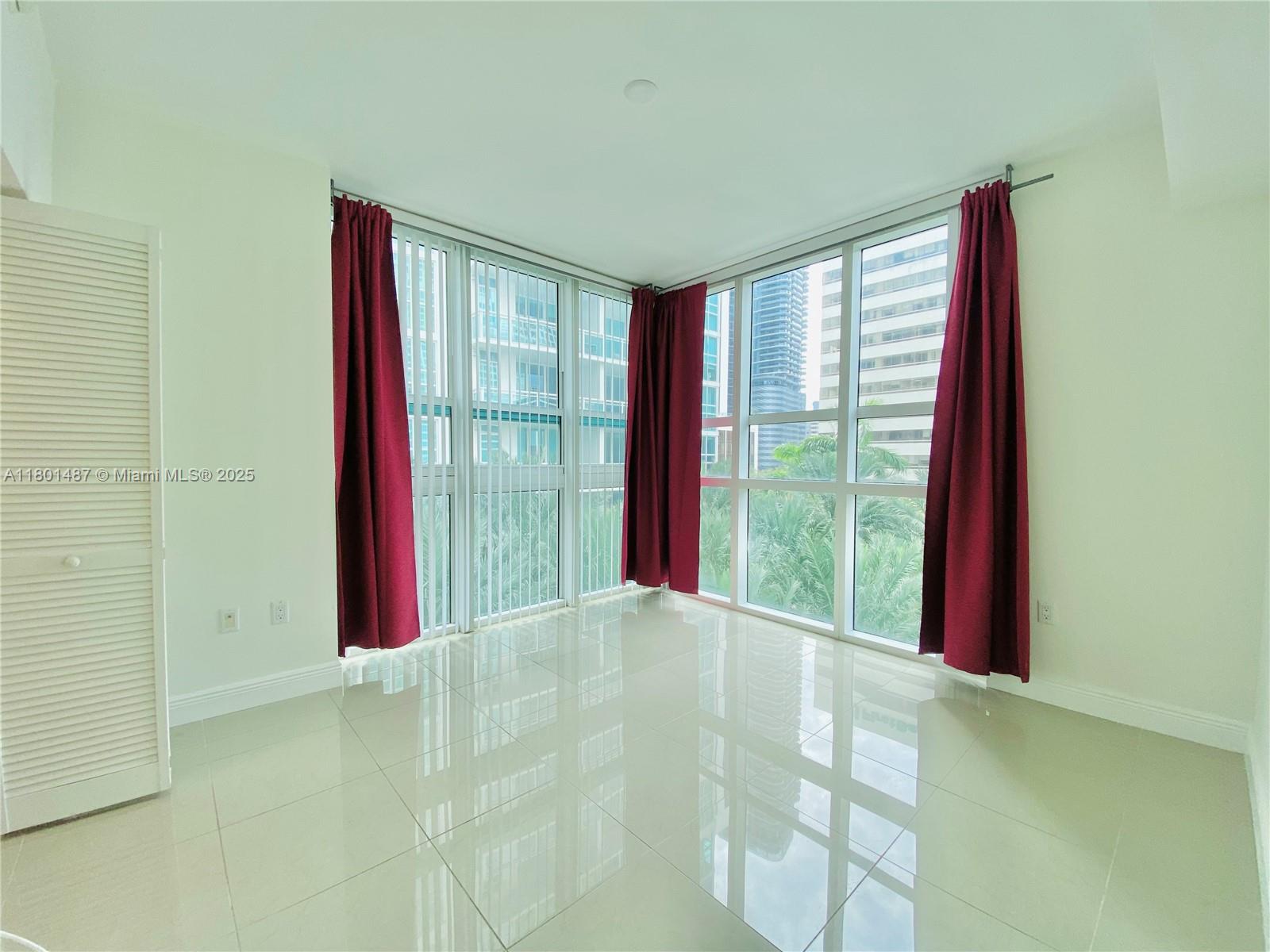 950 Brickell Bay Drive, Unit 401 Miami, FL 33131 - Photo 11 of 28 a view of empty room with floor to ceiling window