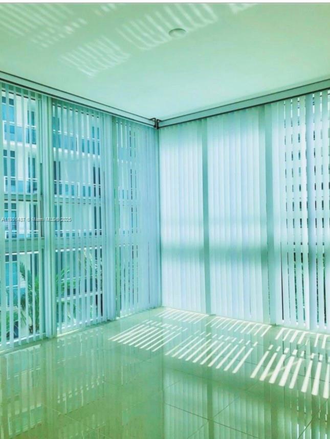 950 Brickell Bay Drive, Unit 401 Miami, FL 33131 - Photo 12 of 28 a bedroom with a bed and a wooden floor