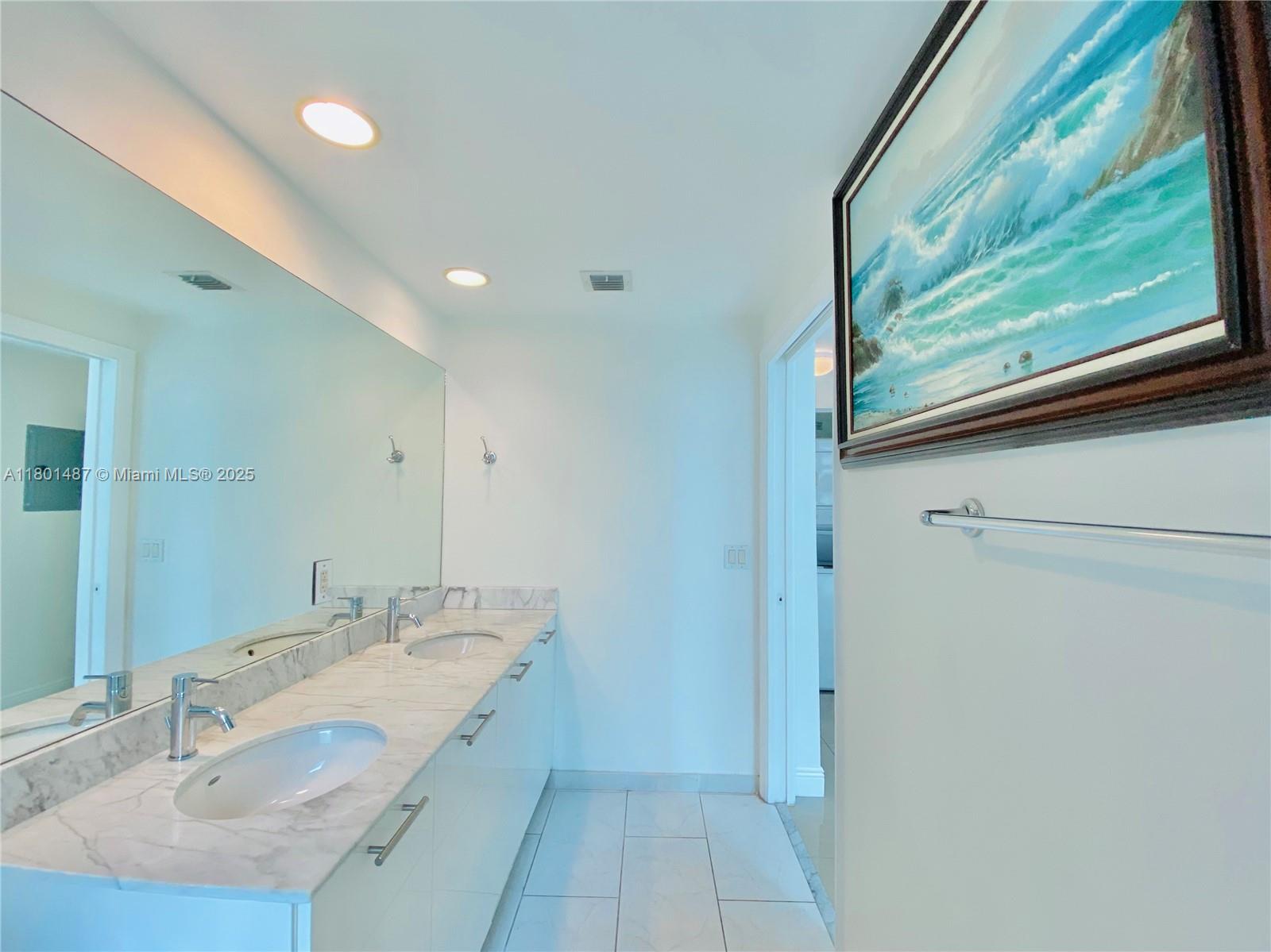 950 Brickell Bay Drive, Unit 401 Miami, FL 33131 - Photo 13 of 28 a bathroom with a double vanity sink and mirror