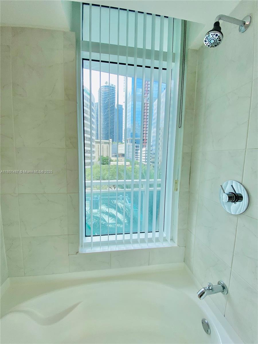 950 Brickell Bay Drive, Unit 401 Miami, FL 33131 - Photo 14 of 28 a bathroom with a shower