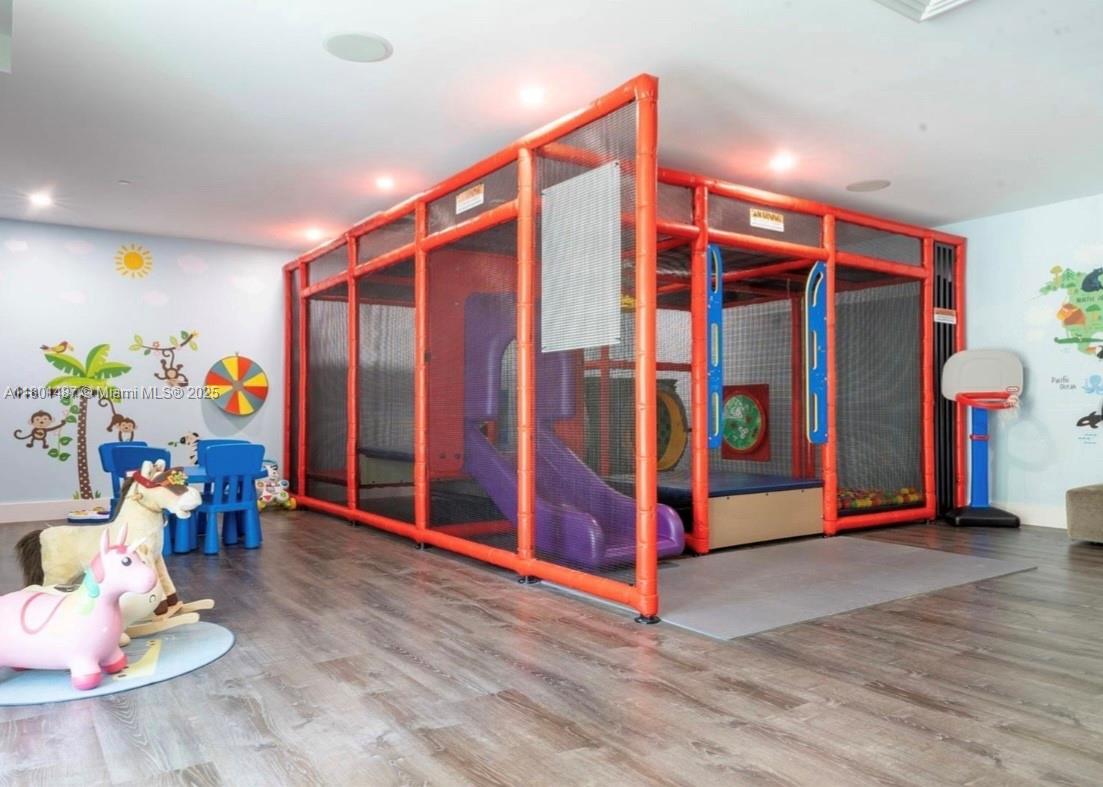 950 Brickell Bay Drive, Unit 401 Miami, FL 33131 - Photo 21 of 28 a utility room with lots of baby toys and wooden floor