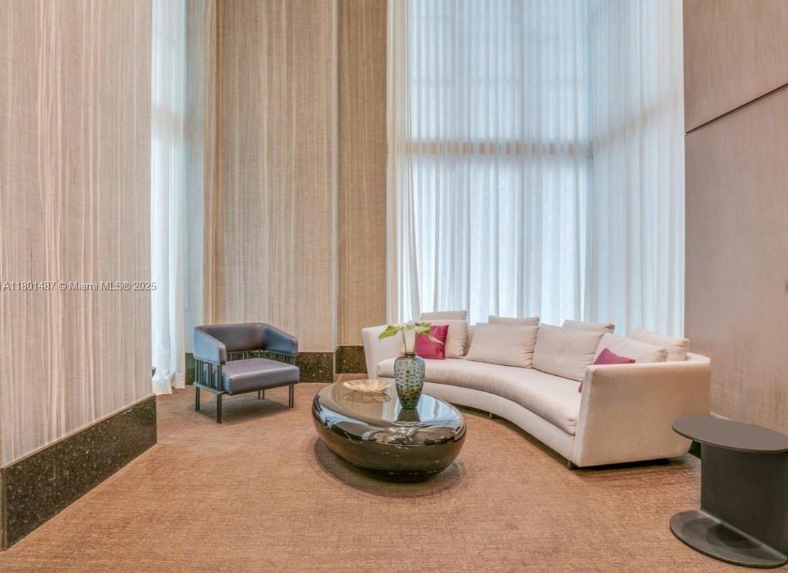 950 Brickell Bay Drive, Unit 401 Miami, FL 33131 - Photo 26 of 28 a living room with furniture and a potted plant