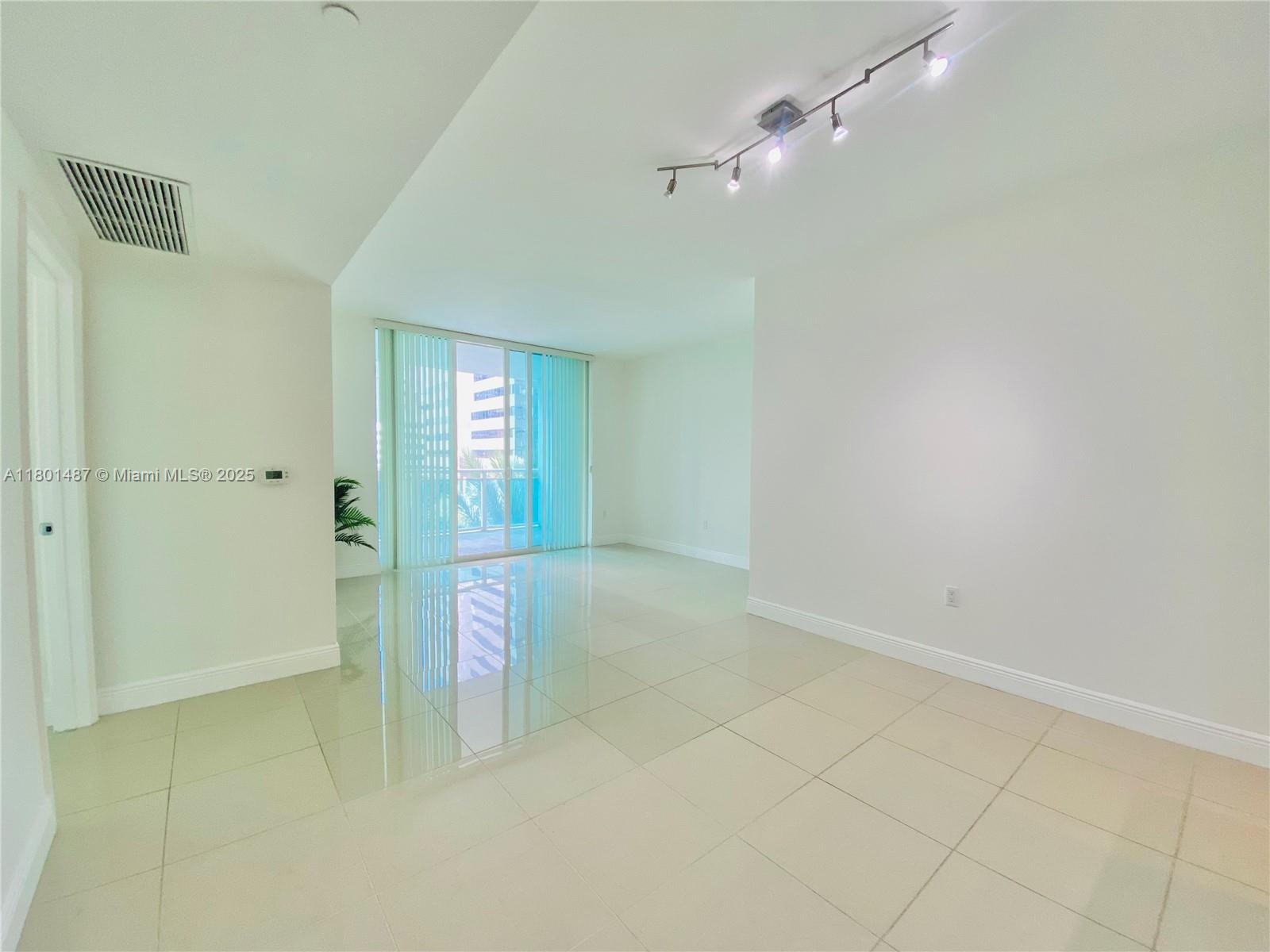 950 Brickell Bay Drive, Unit 401 Miami, FL 33131 - Photo 5 of 28 a view of an empty room with a bathroom