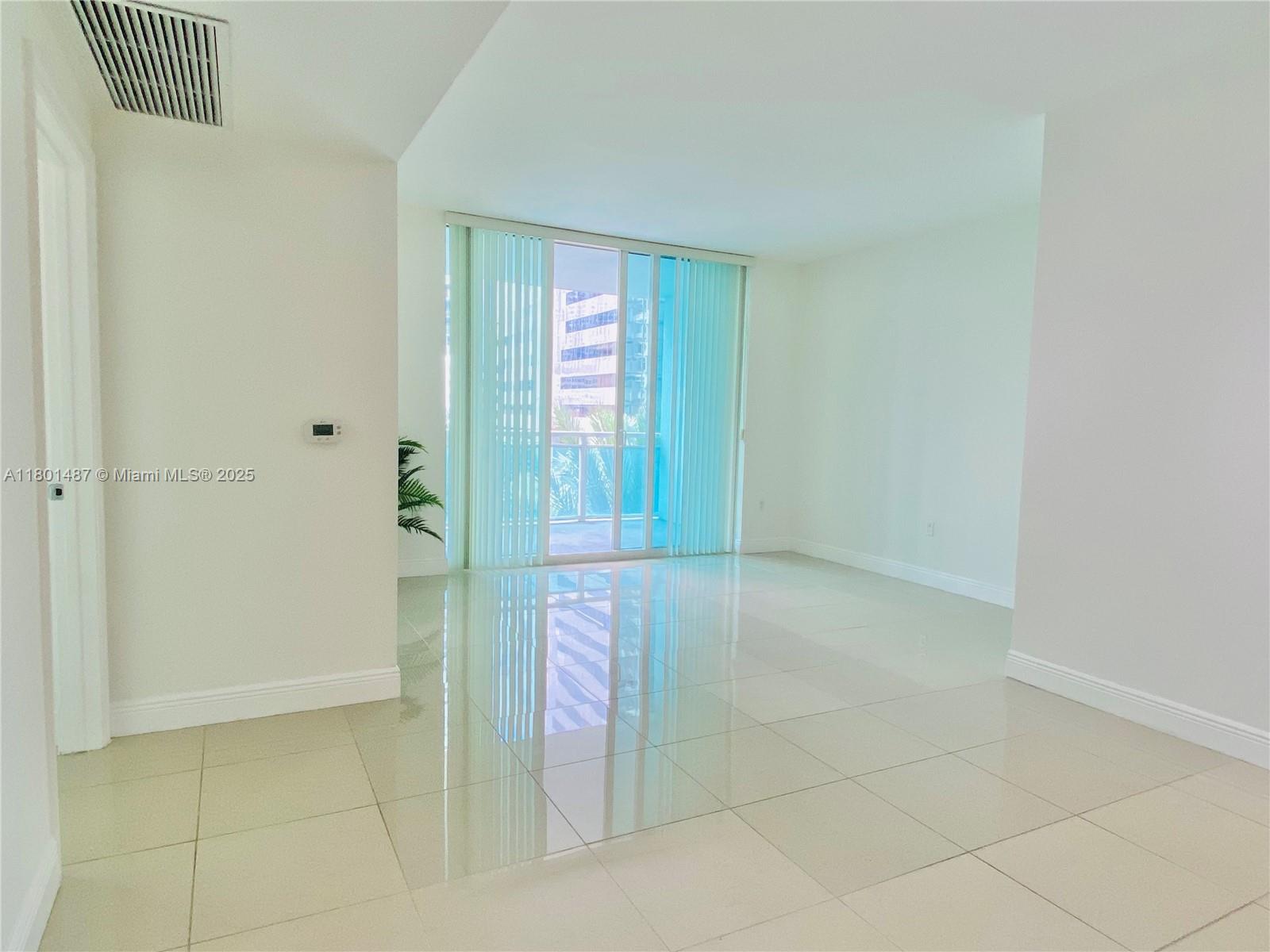 950 Brickell Bay Drive, Unit 401 Miami, FL 33131 - Photo 6 of 28 a view of an empty room and window