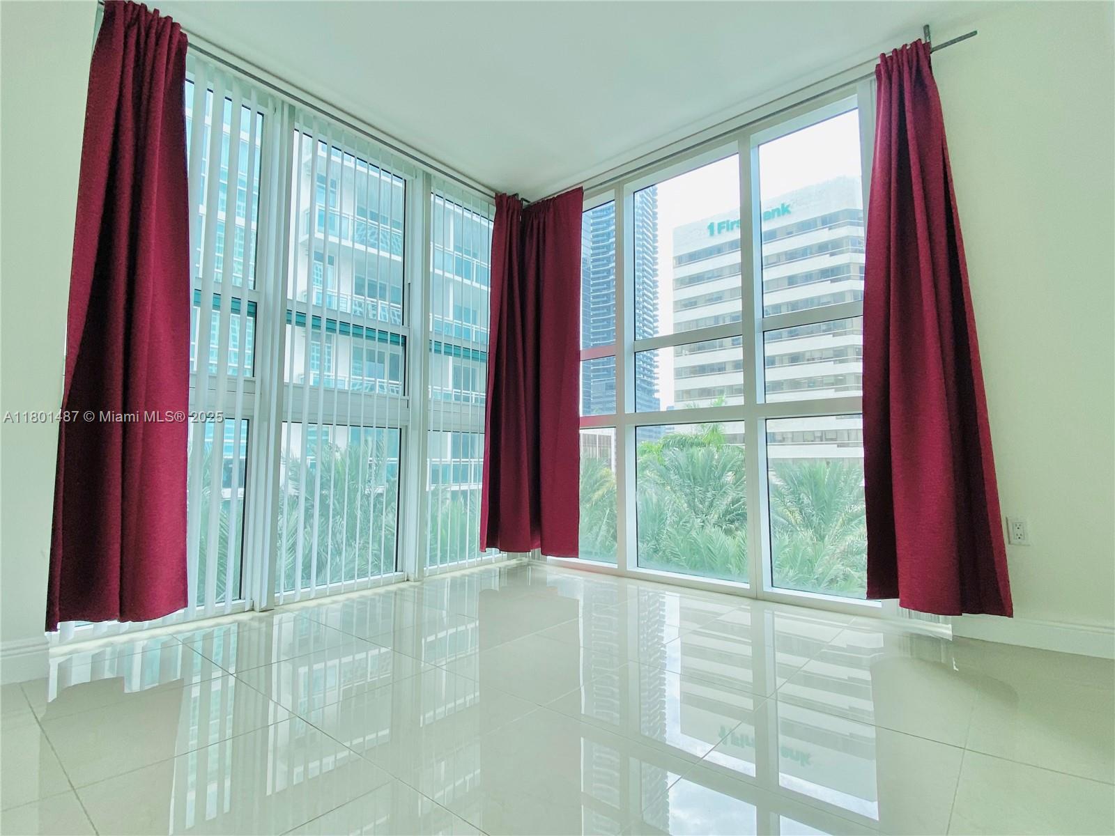950 Brickell Bay Drive, Unit 401 Miami, FL 33131 - Photo 10 of 28 a view of a room with a floor to ceiling window and an outdoor view
