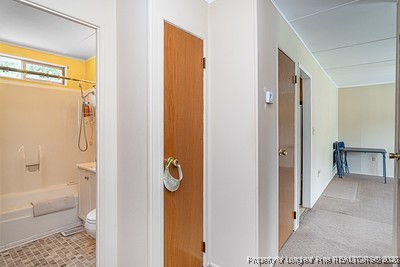 1012 Asbury Road Eastover, NC 28312 - Photo 13 of 38 a bathroom with a tub and a glass door shower