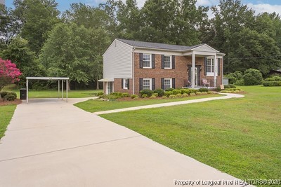 1012 Asbury Road Eastover, NC 28312 - Photo 30 of 38 a front view of a house with a yard table and chairs