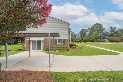 1012 Asbury Road Eastover, NC 28312 - Photo 38 of 38 a front view of a house with a yard and green space