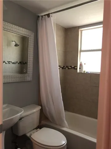 a bathroom with a toilet and a bathtub