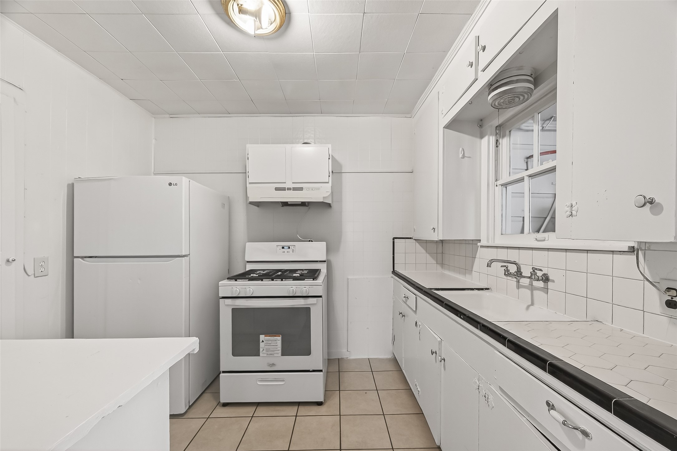 4212 Woodhead Street, Unit 2 Houston, TX 77098 - Photo 11 of 26 a kitchen with a sink cabinets and stainless steel appliances