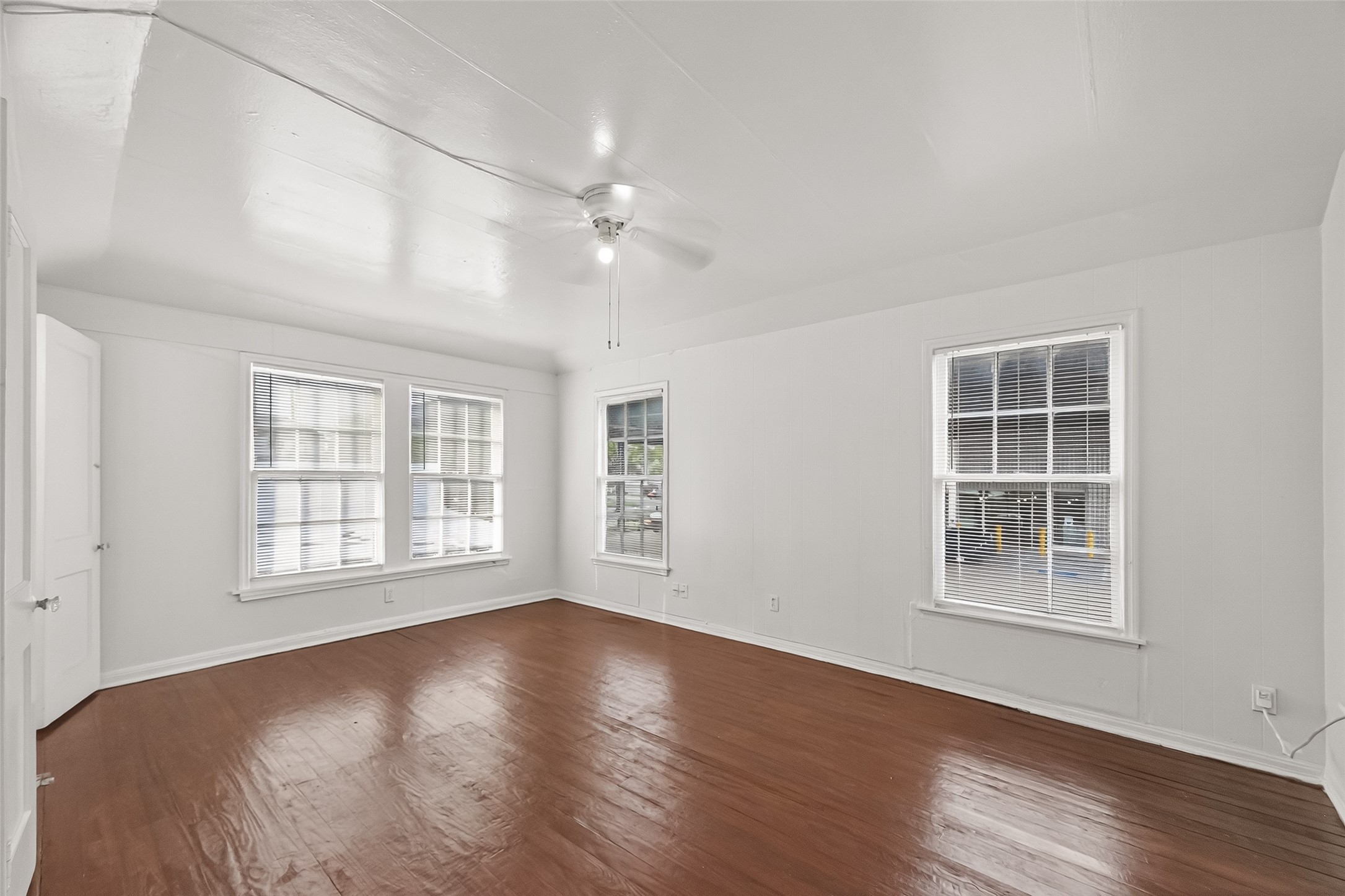 4212 Woodhead Street, Unit 2 Houston, TX 77098 - Photo 13 of 26 a view of an empty room with a window and wooden floor