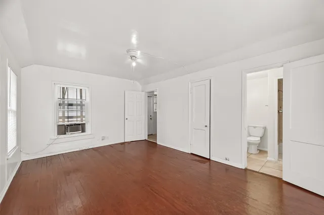 an empty room with a bathroom and a toilet