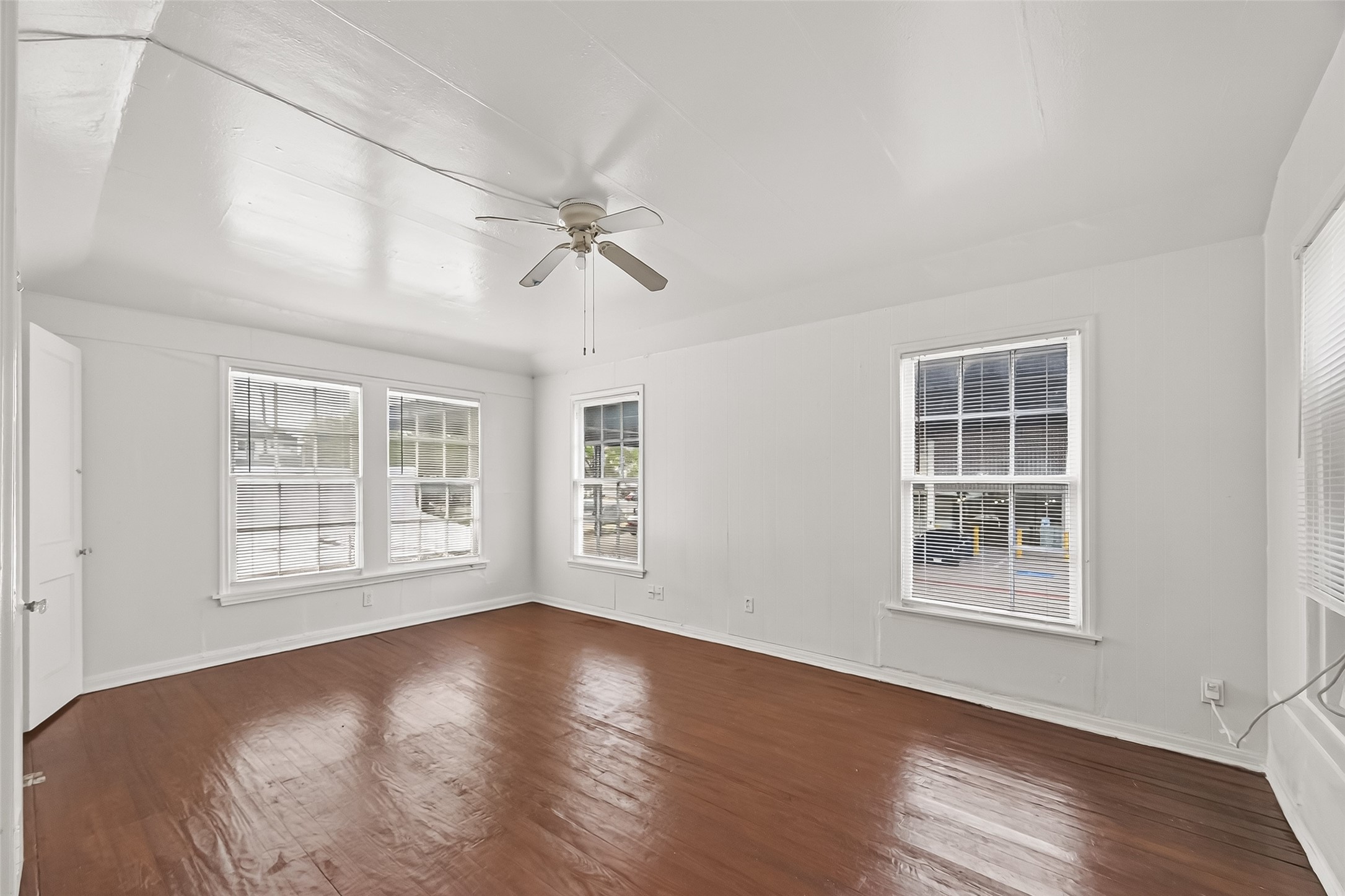 4212 Woodhead Street, Unit 2 Houston, TX 77098 - Photo 17 of 26 a view of an empty room with a window and wooden floor