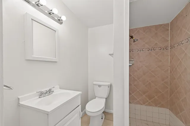 a bathroom with a toilet sink and a mirror
