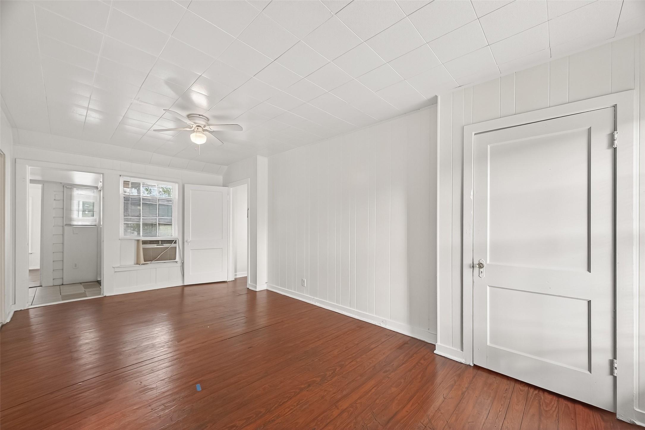 4212 Woodhead Street, Unit 2 Houston, TX 77098 - Photo 7 of 26 wooden floor in an empty room with a window