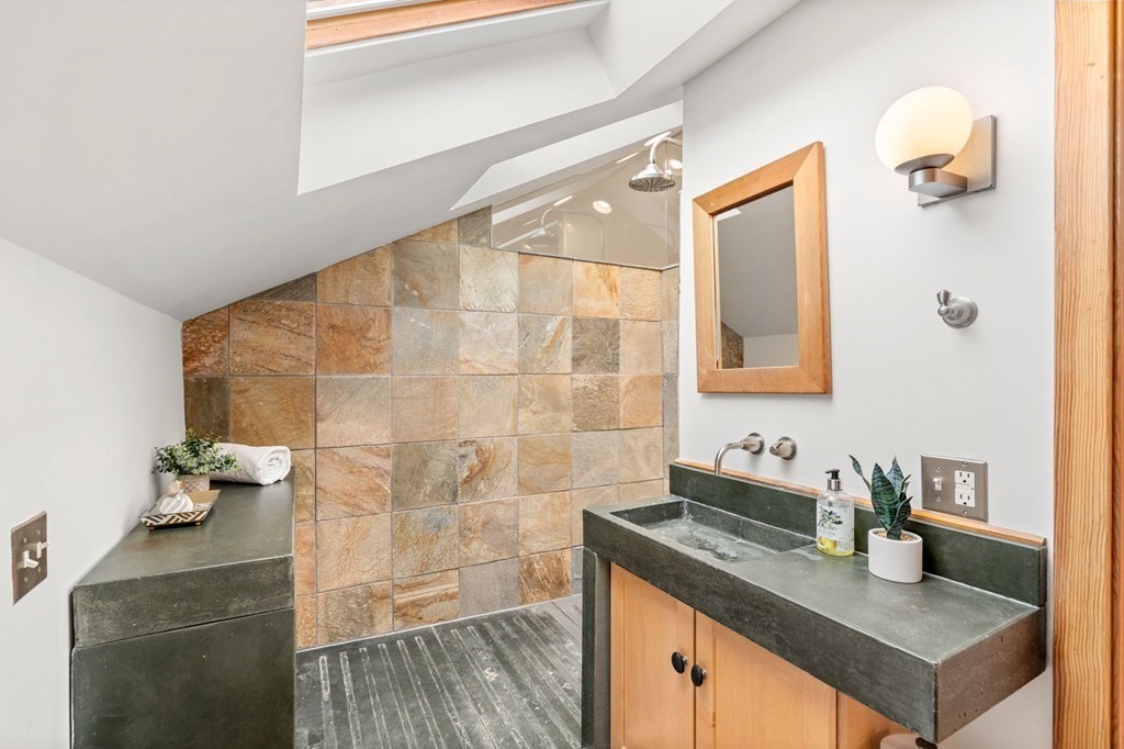 145 Federal Street, Unit 3 Salem, MA 01970 - Photo 14 of 21 a bathroom with a granite countertop sink a mirror and shower