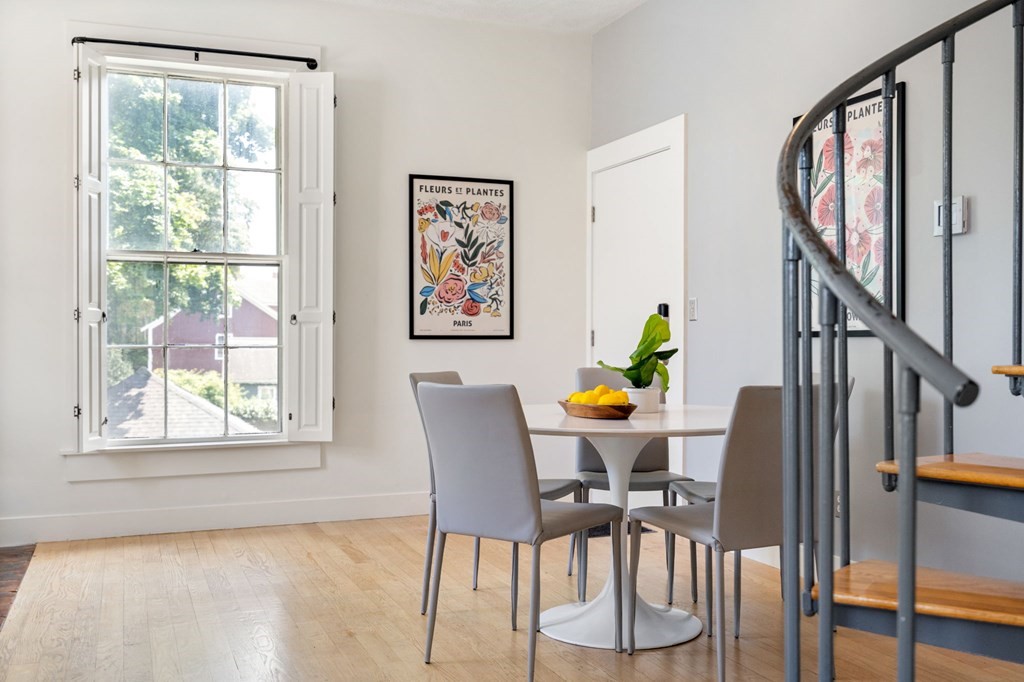 145 Federal Street, Unit 3 Salem, MA 01970 - Photo 4 of 21 a view of a dining room with furniture a potted plant and a window