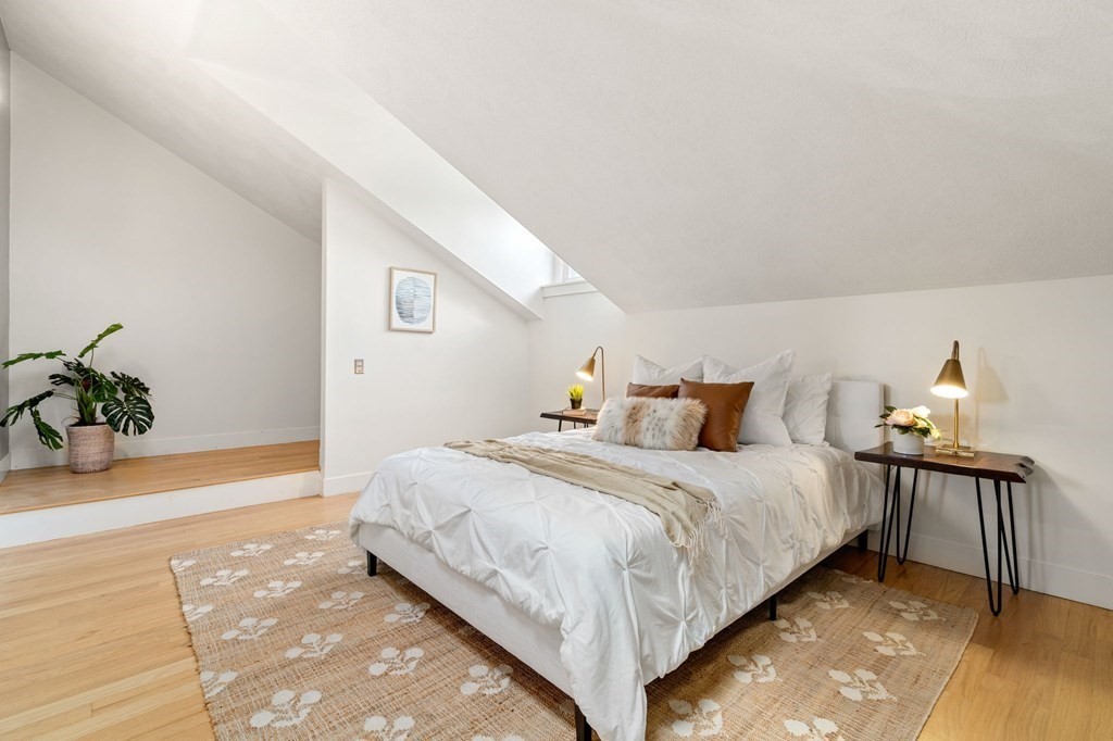 145 Federal Street, Unit 3 Salem, MA 01970 - Photo 10 of 21 a bedroom with a bed and a potted plant on table