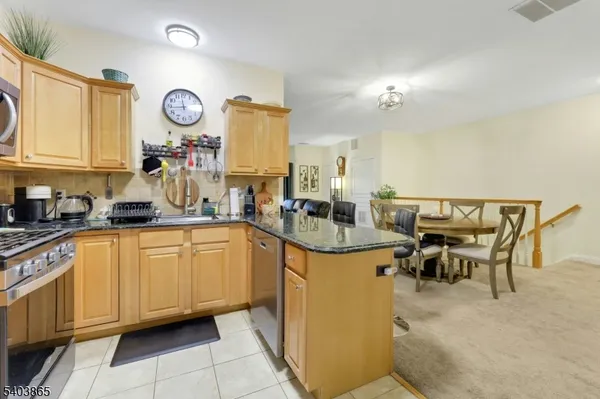 a kitchen with stainless steel appliances granite countertop a sink and cabinets